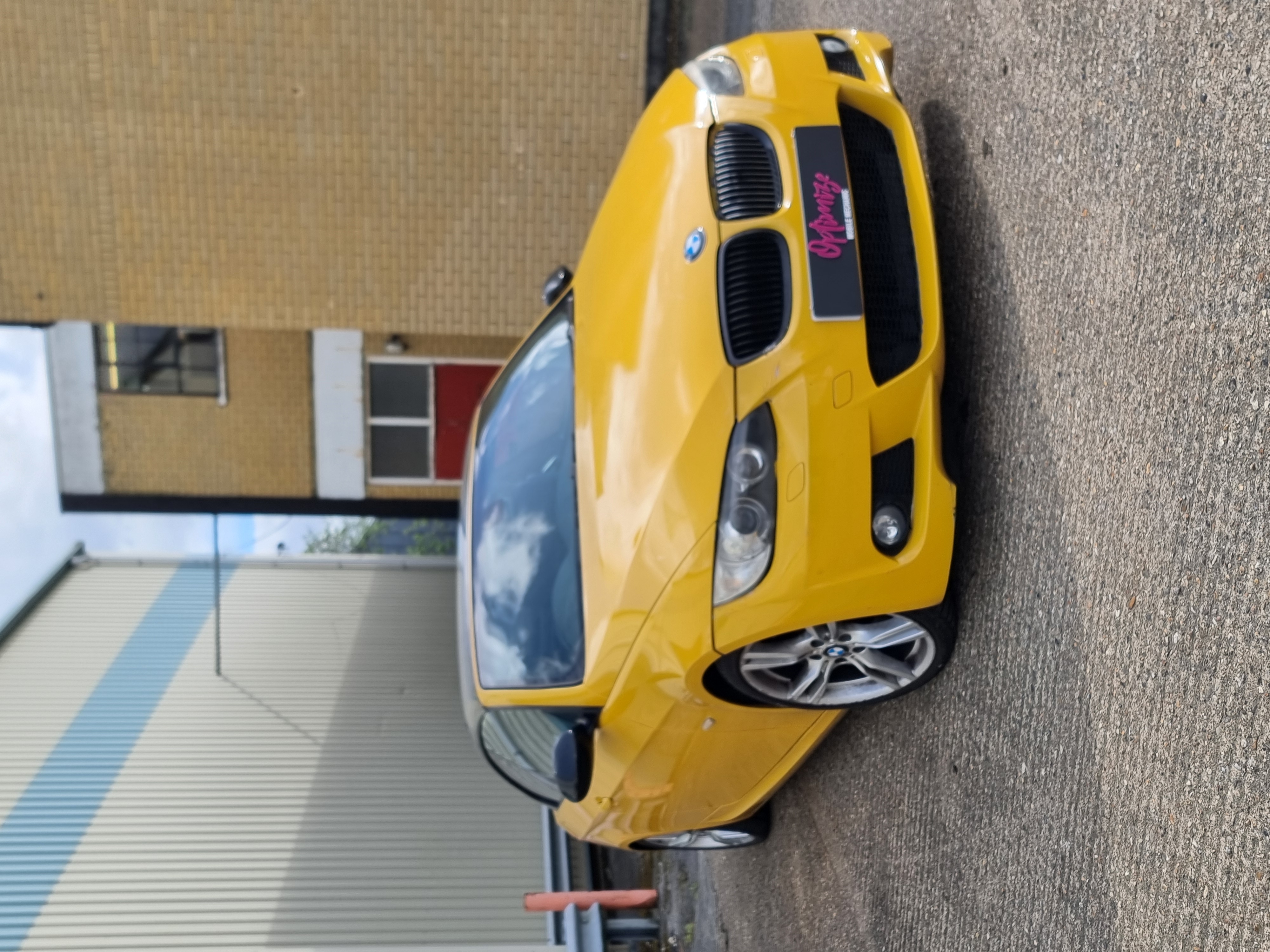 Yellow BMW photographed outside the workshop